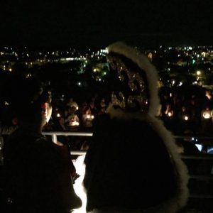 large group of people holding candles